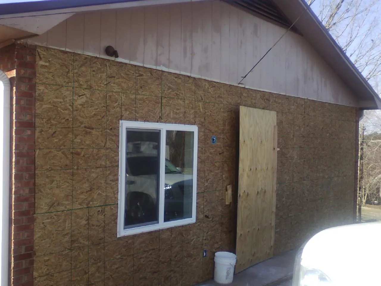 OSB sheathing on a garage addition wall before siding in Arvonia