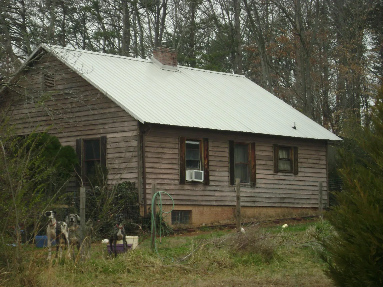 White metal roof on an old wood sided farmhouse, from a Metal Roof Installation job in Arvonia